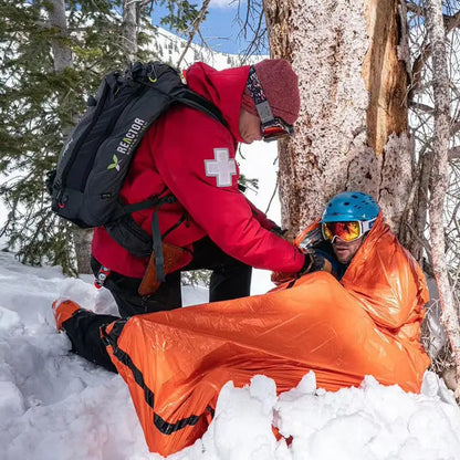 Emergency thermal sleeping bag used in snow during a rescue