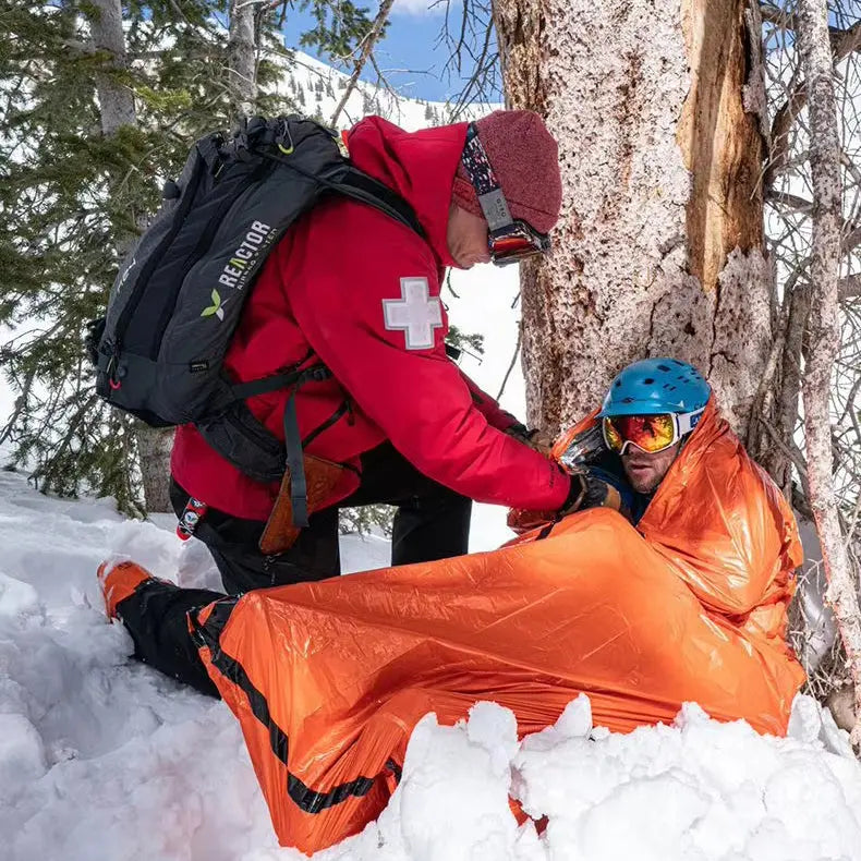 Emergency thermal sleeping bag used in snow during a rescue